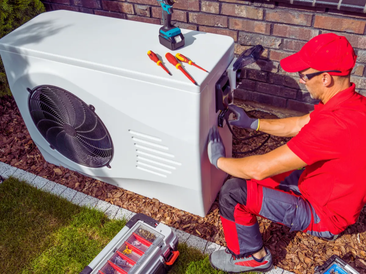 HVAC tech maintaining heat pump